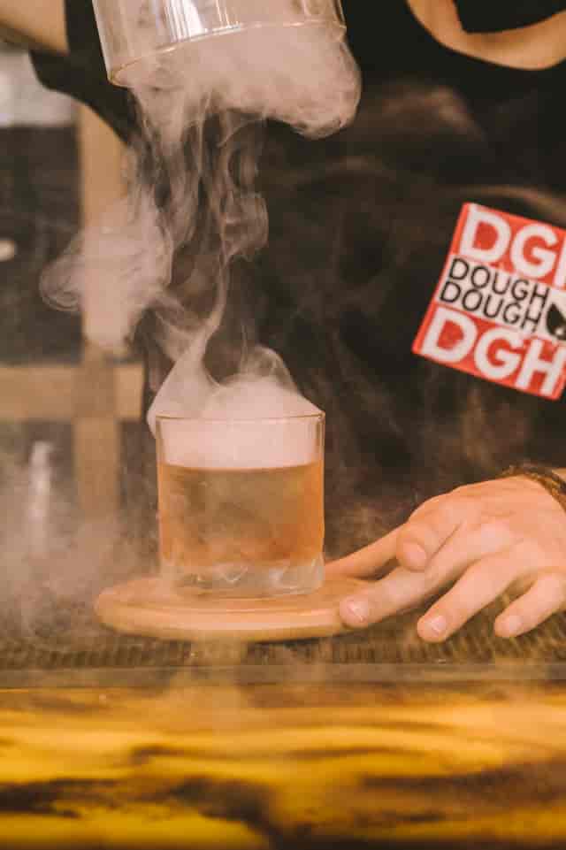 Creative cocktail with smoke effect at Dough Dough Liverpool for memorable events.