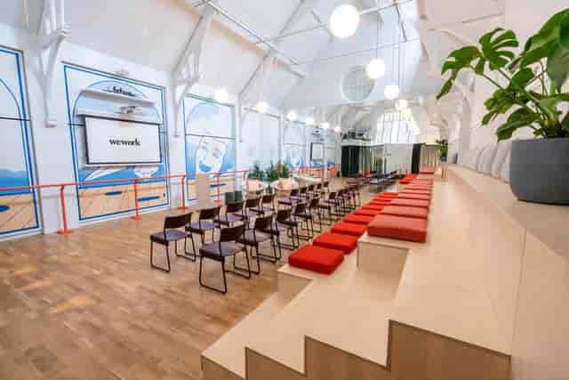 Modern event space with tiered seating, perfect for workshops and presentations.