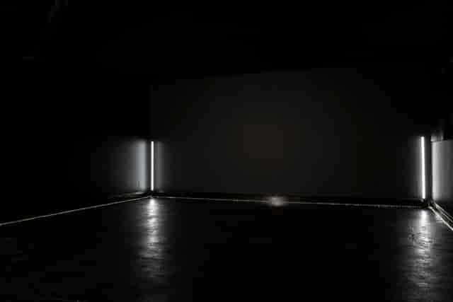 Minimalist event space in Blackout studio with dark walls, ideal for creative events.