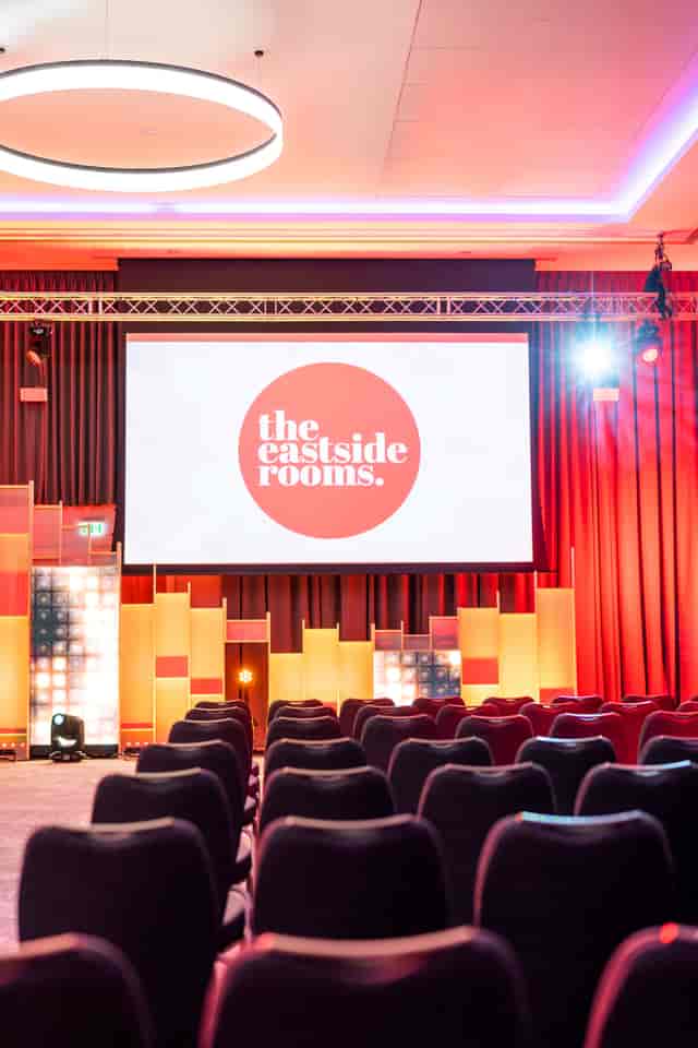 Affinity One event space with large screen, ideal for conferences and presentations.