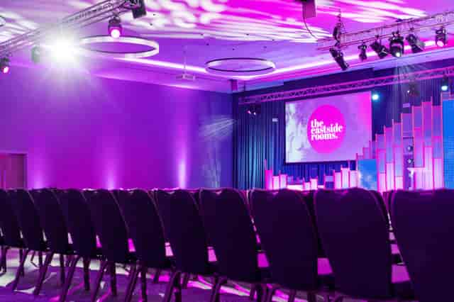 Affinity Two conference space with elegant chairs and vibrant stage, perfect for events.