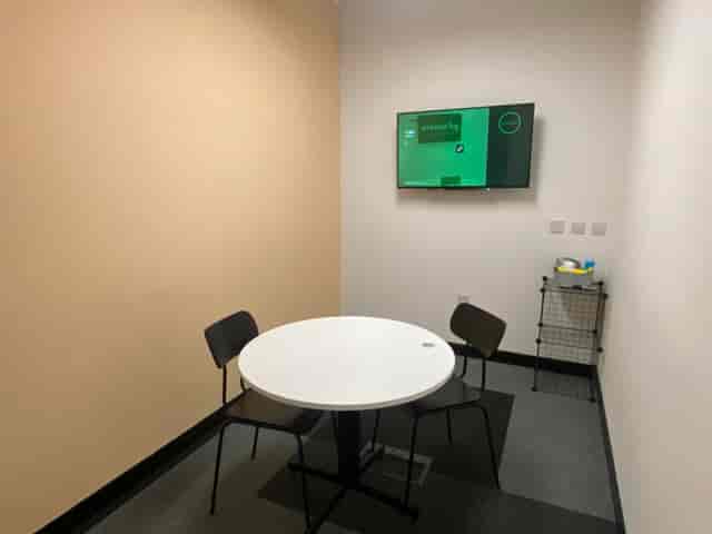 Modern meeting room with round table for collaborative brainstorming sessions at Avenue HQ.