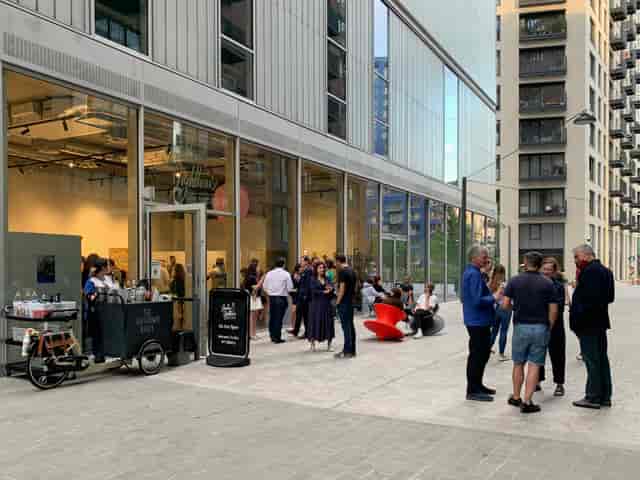 Outdoor networking event at London Lighthouse Gallery with vibrant seating and refreshments.