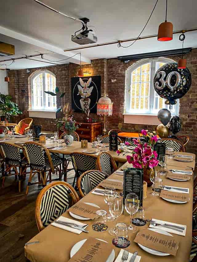 Mala Madre event space with elegant table settings for milestone celebrations.