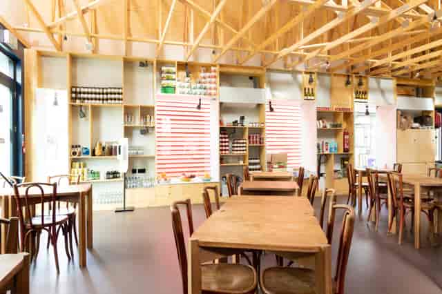 Modern open-concept venue with warm wood decor for casual meetings and events.