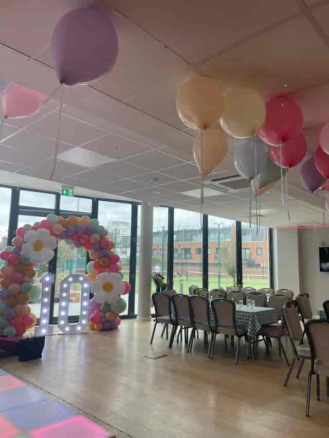 Vibrant Oval Room at Parsons Green Club with colorful balloon arch for celebrations.