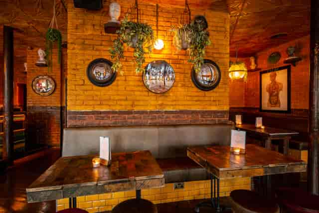 Cozy dining space with warm brick walls, perfect for networking events in Camden Assembly.