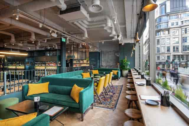 Modern lounge with vibrant seating, ideal for meetings and events in VAGABOND MONUMENT.