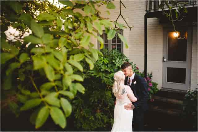 Couple in The Pembroke Suite, lush greenery backdrop for romantic weddings and events.