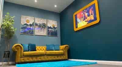 Stylish lounge area with yellow couch for networking events at Tribe Urban Studios.