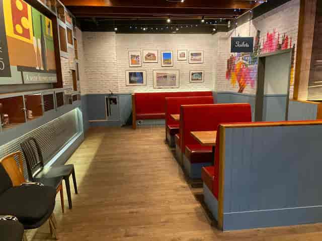 Cozy LDN Craft bar with red booths, ideal for team-building and intimate gatherings.