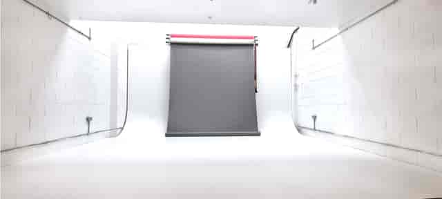 Minimalist photography studio with gray backdrop for events and video shoots.