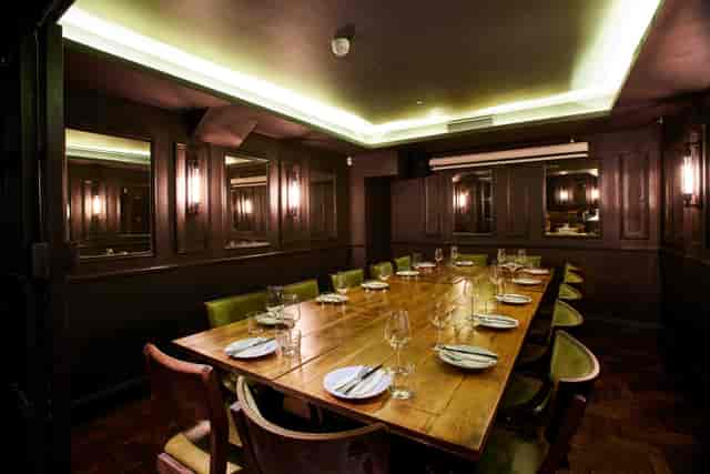 Private dining room with rich wood paneling for executive board meetings and corporate events.