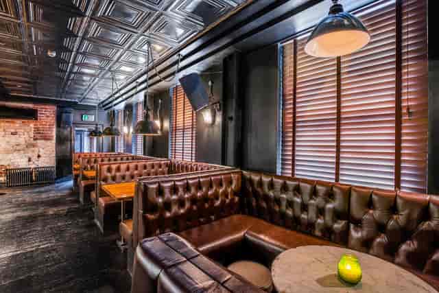 Stylish modern venue with leather booths for intimate meetings and networking events.