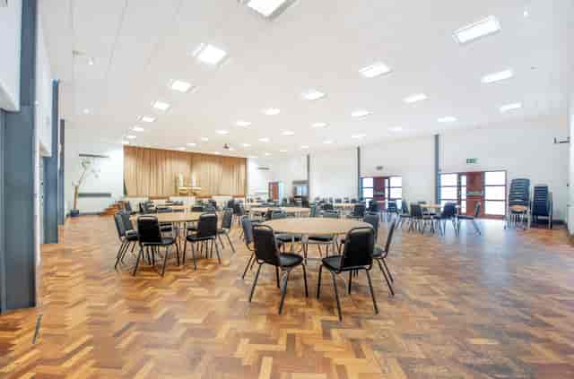 Spacious St Georges Community Hub Hall with polished wooden floor for events and conferences.