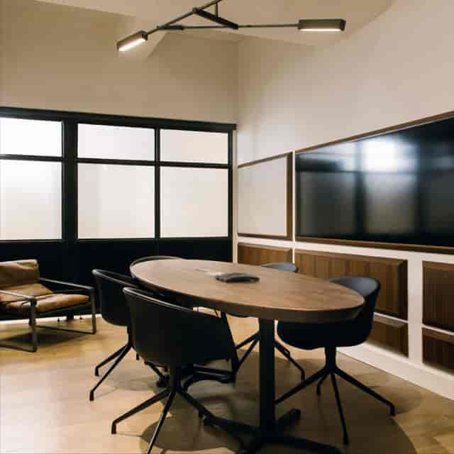 Modern meeting room with oval table, ideal for presentations and brainstorming sessions.