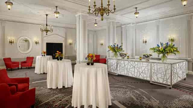 Elegant event space with high-top tables, ideal for corporate receptions and gatherings.
