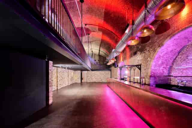 Stylish industrial event space with exposed brick, ideal for corporate and social gatherings.