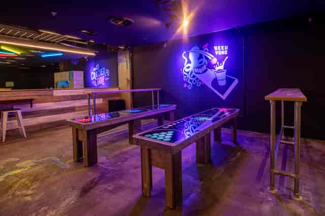 "Boom Battle Bar event space with neon lights for interactive social gatherings"
