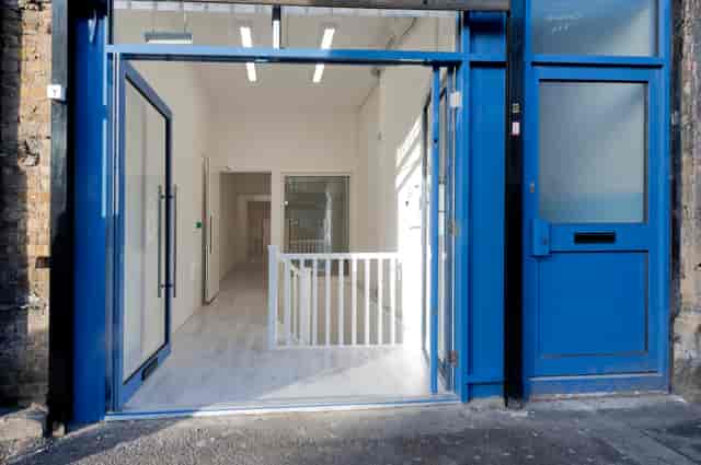 Spacious modern venue entrance with glass doors for corporate events and workshops.