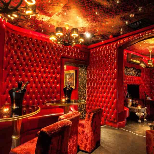 Luxurious Red Room at 1989 Clubhouse, ideal for upscale cocktail parties and events.