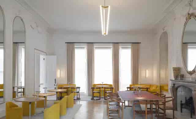 Cromwell Place Café Bar: stylish meeting space with yellow seating for workshops and gatherings.
