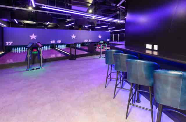Duckpin Lounge at O2: vibrant bowling alley with neon lights for events and gatherings.