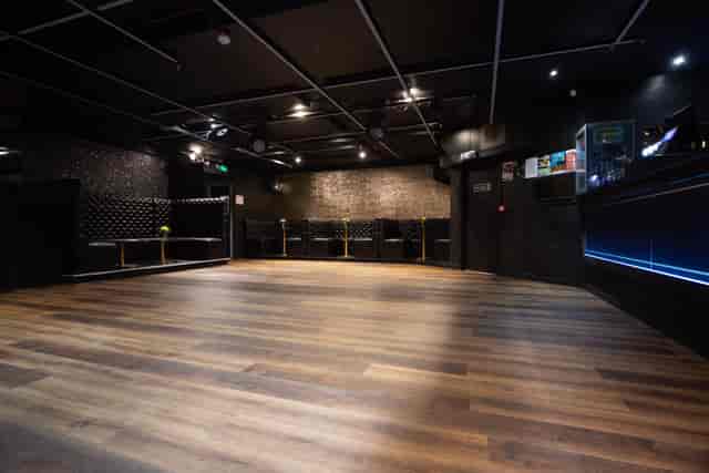 Main Room at Aura Tunbridge Wells: modern event space with elegant dark walls, ideal for gatherings.