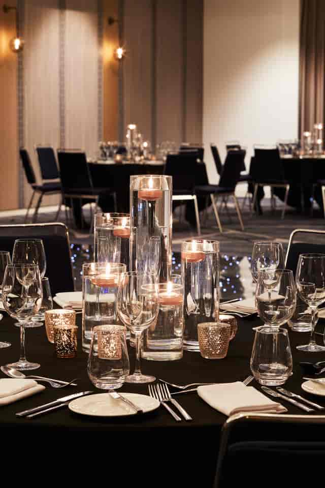 Elegant dining table with glass centerpieces for formal events at Hyatt Regency Manchester.