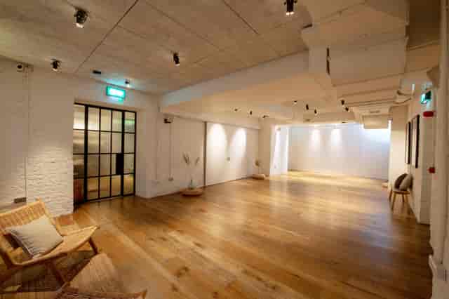 White Room at Carousel London, modern event space with warm wooden flooring for gatherings.
