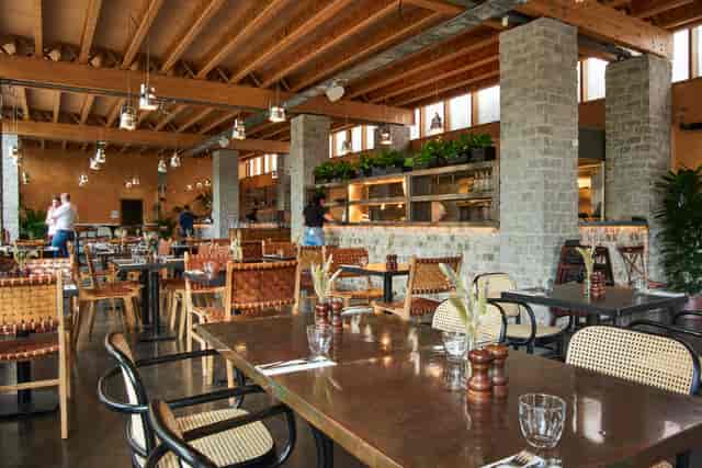 Modern restaurant interior with natural light, perfect for casual meetings and events.