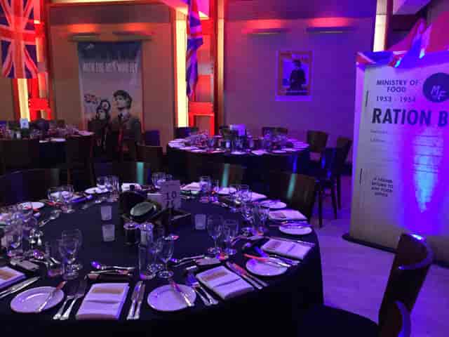 HCA Auditorium set for a formal dinner with elegant tables and vibrant decor.
