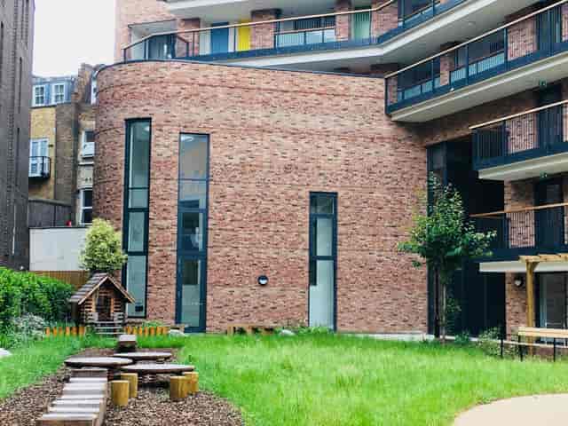 Modern brick-clad lecture hall with outdoor space for events and team-building activities.