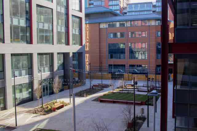 Versatile outdoor event space in New Bailey Square with modern architecture and string lights.