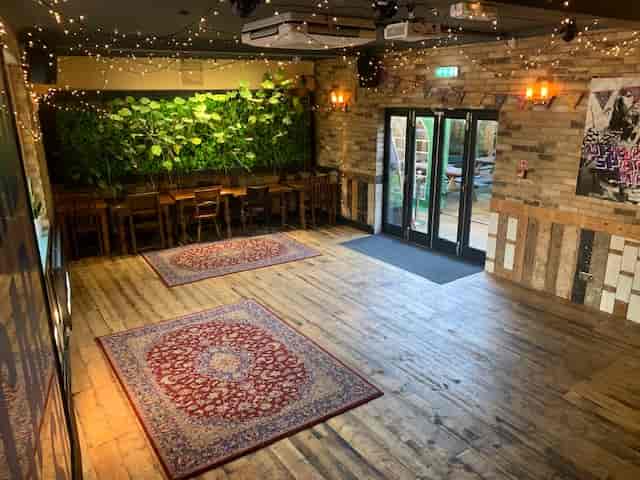 Function Room at The Village Green: versatile event space with wooden flooring, ideal for gatherings.