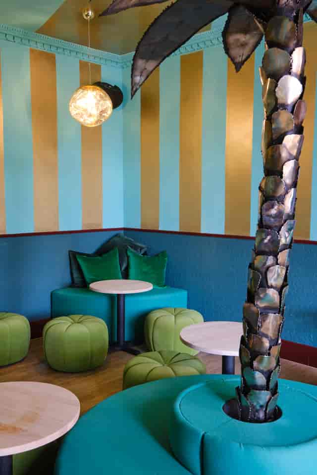 Vibrant Miami Bay meeting space with bold blue and gold stripes, perfect for events.