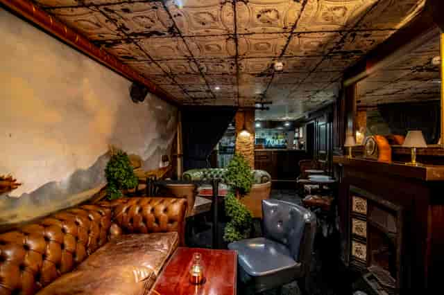 Cozy vintage lounge with leather seating at The Goat Chelsea for intimate events.