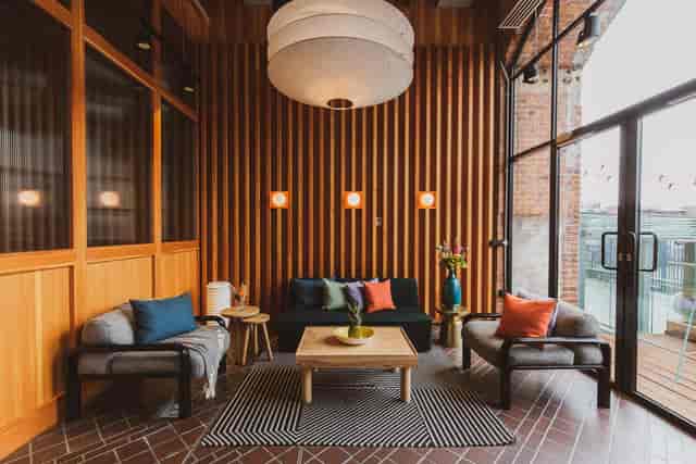 Stylish lounge area with warm wood paneling for networking events and meetings.