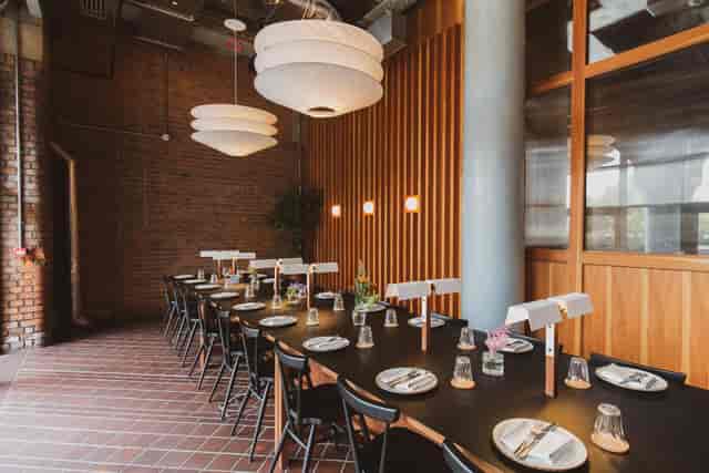 Stylish meeting space with warm brick walls for corporate events and private dinners.