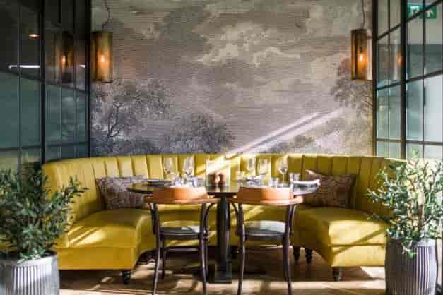 Private dining at Brasserie Blanc, Fulham: yellow banquette seating for corporate networking events.