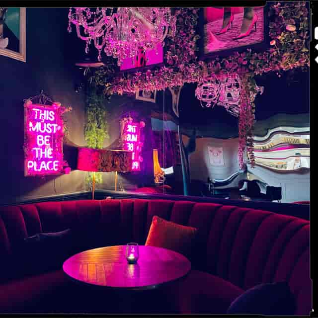 Vibrant Imperial Arms Lounge with neon signs, ideal for networking and social events.