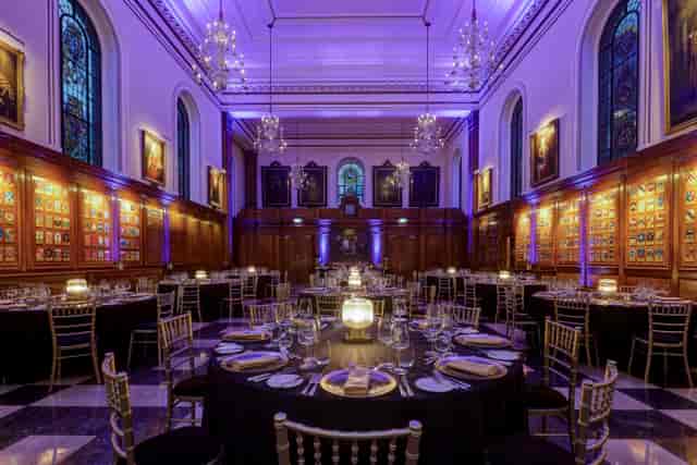 Inner Temple Hall gala with purple uplighting, banquet seating, and elegant decor for corporate events.