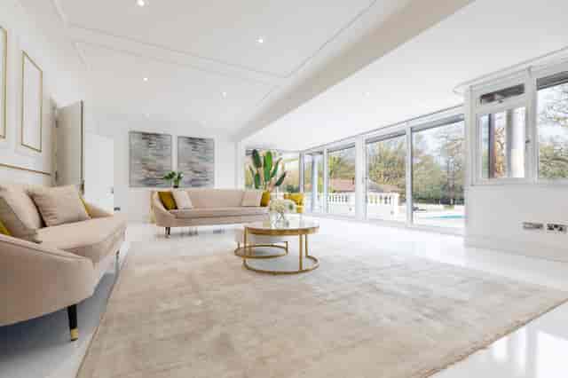Modern event space at The Villa Mansion with large windows for natural light.