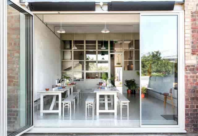 Modern event space with large windows, ideal for workshops and gatherings.