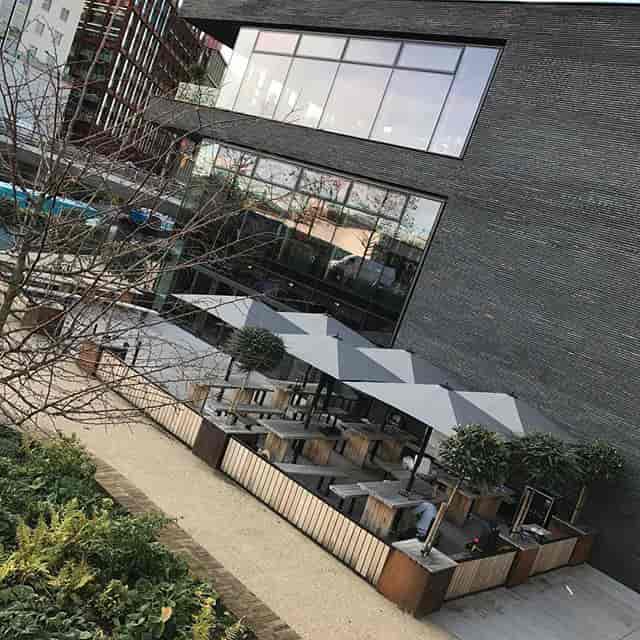 Canalside Bar & Terrace at The Lighterman, featuring modern cabanas for outdoor events.