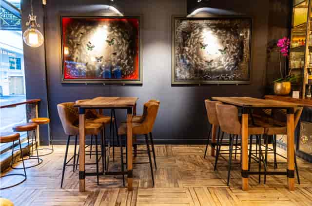 Stylish event space with high-top tables for networking and cocktail receptions.