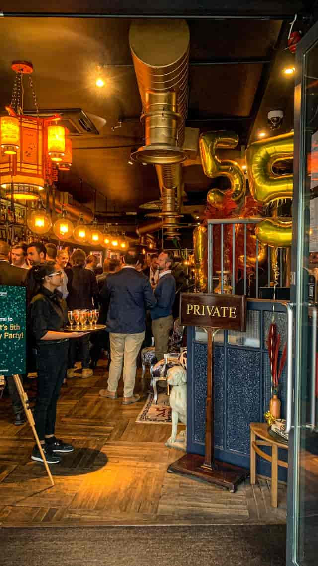 Vibrant private event at The Last Talisman venue with warm lighting and festive decor.