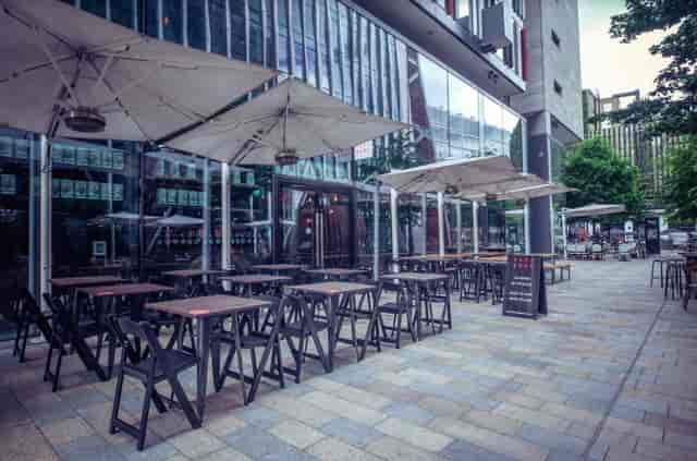 Royal box outdoor dining area with modern architecture, ideal for networking events.