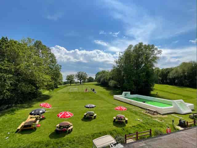 Outdoor event venue at Horsenden Hill with green lawn and inflatable pool.