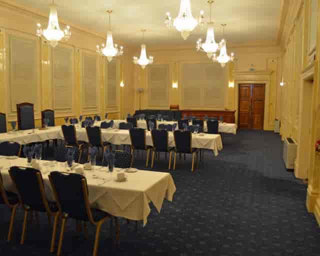 Elegant meeting room with chandeliers, ideal for corporate events and formal gatherings.